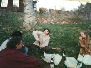 A group of people sitting in the grass
	Description automatically generated